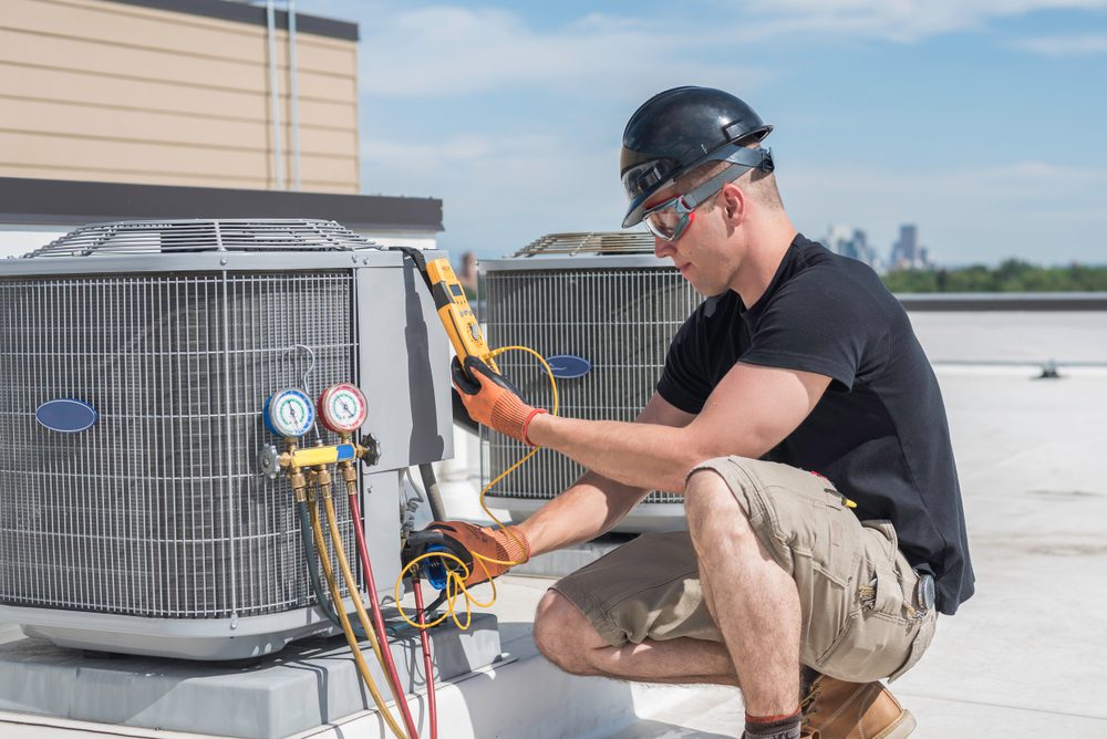 HVAC technician servicing a commercial rooftop unit
